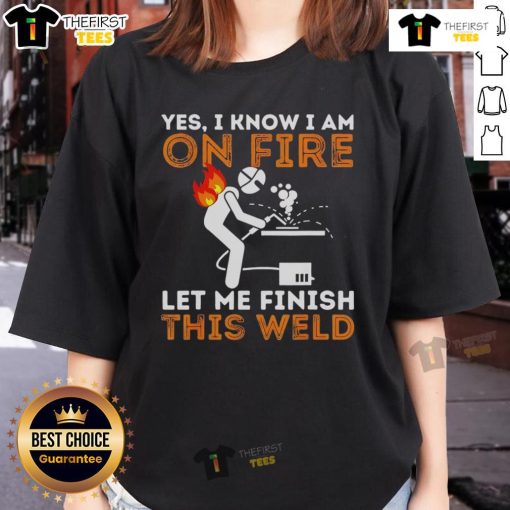 Pretty metal worker in a welding mask confidently finishing a weld, showcasing the 'Pretty Yes I Know I Am On Fire' tee.
