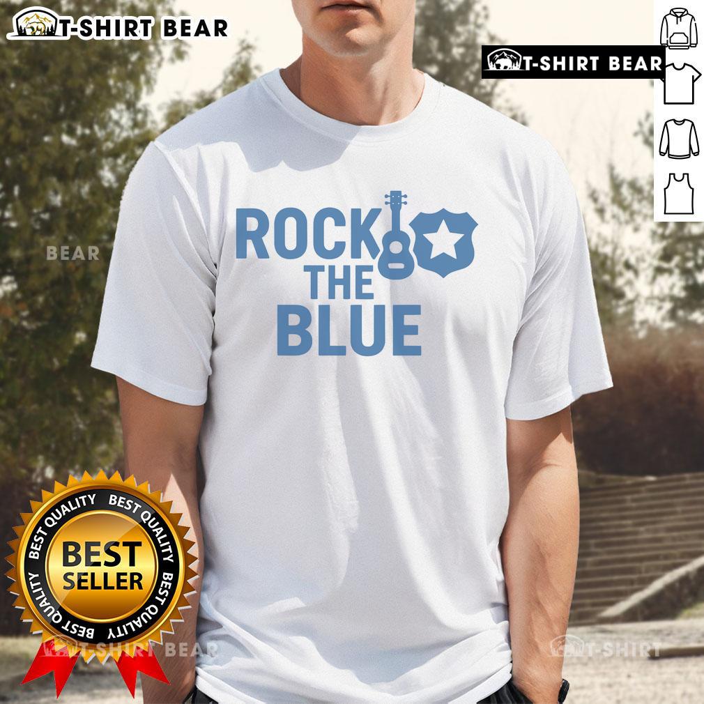 Top Guitar And Badge Rock The Blue T Shirt Top Guitar and Badge Rock the Blue T-Shirt featuring a vibrant guitar graphic on a stylish blue background.