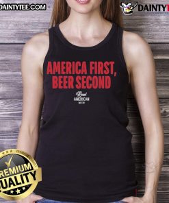 Alt Text: Hulk Hogan wearing an 'America First Beer Second' tank top, showcasing his iconic wrestling persona and patriotic spirit.