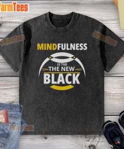 Top mindfulness is the new black washed t-shirt displayed on a hanger with a minimalist background.