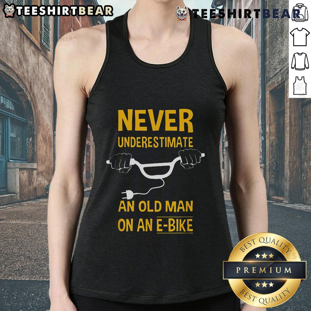 Top Never Underestimate An Old Man On An E Bike Tank Top Man wearing 'Never Underestimate An Old Man On An E-Bike' tank top, showcasing confidence and style on an electric bike.