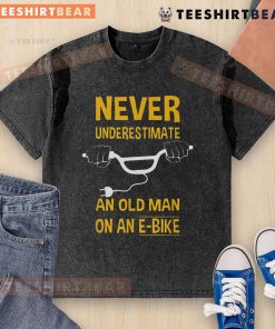 Top Never Underestimate An Old Man On An E-Bike Washed T-Shirt featuring a bold graphic and comfortable fit.