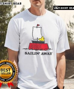 Alt Text: Top Peanuts Sailin Away T-Shirt featuring Snoopy and friends on a colorful sailing adventure design.