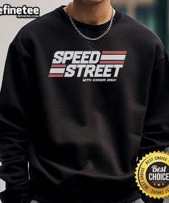 Conor Daly wearing a Top Speed Street sweatshirt, showcasing style and speed at a racing event.