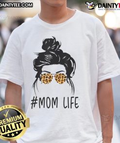 Alt Text: Classy mom wearing a leopard pattern shades t-shirt with a cool messy bun, showcasing stylish mom life vibes.