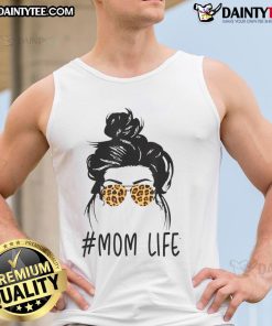 Classy mom in leopard pattern shades and a cool messy bun, wearing a stylish tank top, embodies awesome mom life.