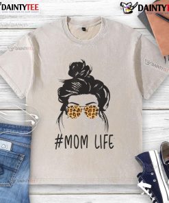 Classy mom life with leopard pattern shades, cool messy bun, and a washed t-shirt, showcasing effortless style.