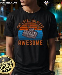 Awesome Dad Level Unlocked Retro Gamer Sunset T-Shirt featuring a vibrant design of gaming controllers and a sunset backdrop.