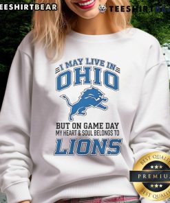 Ohio fan wearing Detroit Lions sweatshirt, showcasing team spirit on game day with vibrant colors and bold logo.
