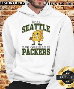 Fan wearing a Green Bay Packers hoodie, showcasing team spirit on game day in Seattle.