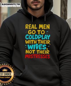 Awesome Real Men Go To Coldplay With Their Wives Hoodie worn by a couple at a concert, showcasing their love for music.