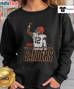Shedeur Sanders wearing a Cleveland Browns 'Believe' sweatshirt, showcasing team spirit and style.
