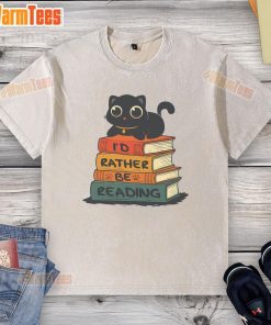 Alt Text: Cute cat lounging on a 'I Would Rather Be Reading' washed t-shirt, showcasing a cozy reading vibe.