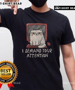 Cute cat on keyboard graphic on 'I Demand Your Attention' t-shirt, perfect for cat lovers and humorous apparel.