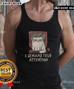 Alt Text: Cute cat lounging on a keyboard, showcasing the 'I Demand Your Attention' tank top in a cozy home setting.