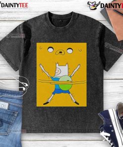 Cute Finn the Human hugging a plush toy, wearing a washed t-shirt featuring Adventure Time characters.
