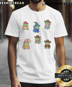 Alt Text: Cute frogs dressed as cowboys and witches on a playful T-shirt design featuring colorful cartoon characters.