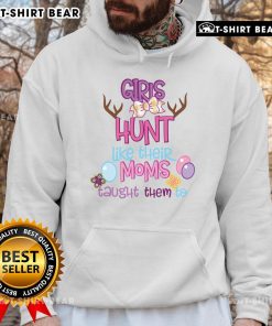 Two cute girls in matching hoodies hunting for Easter eggs, showcasing their skills learned from their moms.