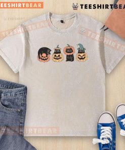 Cute Halloween cat sitting on a pumpkin, featured on a washed t-shirt design perfect for festive autumn celebrations.