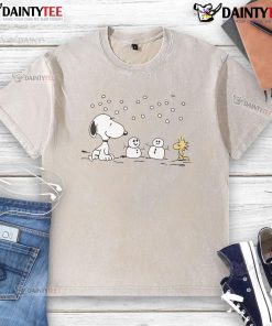 Alt Text: Cute Peanuts Snoopy and Woodstock winter snowman design on a washed t-shirt, perfect for cozy seasonal wear.