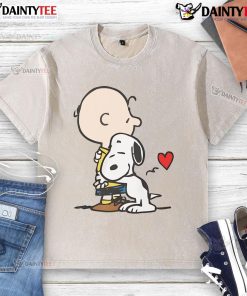 Cute Peanuts Snoopy hugging on a washed t-shirt, perfect for fans of classic cartoon apparel.