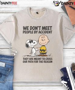 Cute Peanuts Snoopy t-shirt with We don't meet people by accident quote, perfect for fans of Peanuts and whimsical fashion.