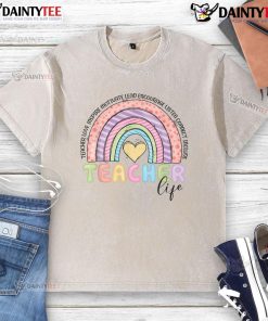 Cute rainbow design on a teacher's washed t-shirt for the last day of school, celebrating teacher life.