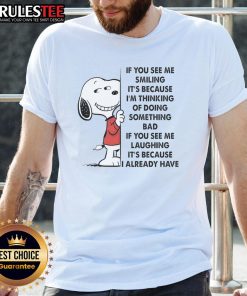 Alt Text: Cute Snoopy t-shirt with 'If You See Me Smiling It's Because I'm Thinking Of Doing Something Bad' graphic.