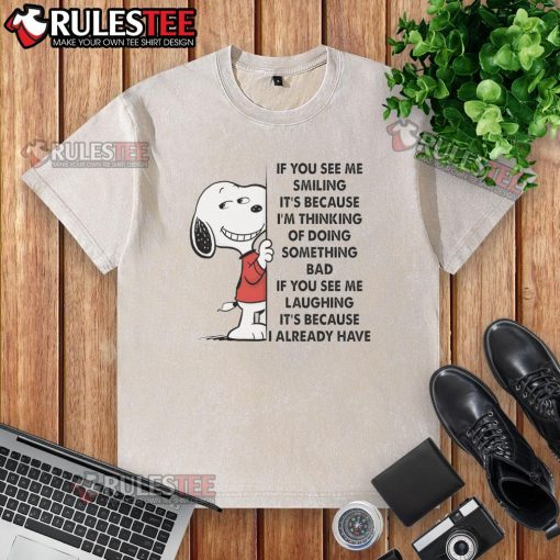 Alt Text: Cute Snoopy t-shirt with 'If you see me smiling, it's because I'm thinking of doing something bad' design.