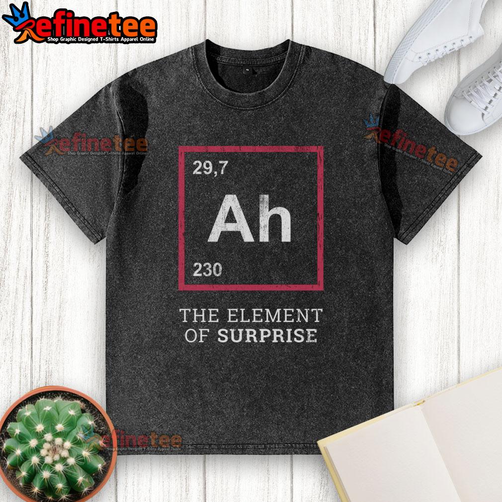 Funny Ah The Element Of Surprise Washed T Shirt Funny 'Ah! The Element of Surprise' washed t-shirt displayed on a wooden background, perfect for humor lovers.