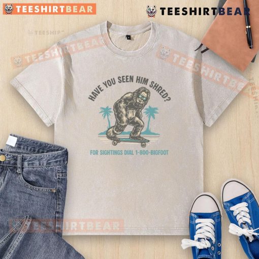 Funny Bigfoot skateboarding on a washed t-shirt, showcasing a whimsical design of him shredding on a skateboard.