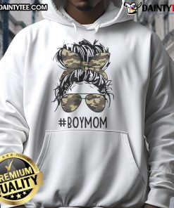 Mom of boys wearing a hoodie with a messy bun, embracing funny motherhood moments in a playful setting.