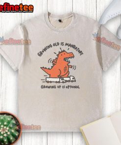 Funny Dino graphic on a washed t-shirt with text: 'Growing old is mandatory, growing up is optional.'