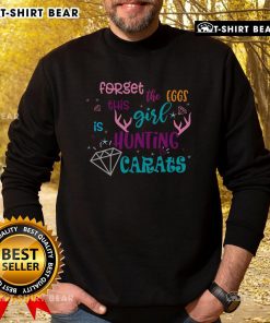 Girl wearing 'Forget the Eggs, This Girl Is Hunting Carats' sweatshirt, smiling and searching for Easter diamonds outdoors.