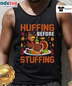 Funny huffing before stuffing Thanksgiving turkey, featuring a humorous wine-themed tank top for holiday celebrations.