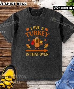 Funny Thanksgiving t-shirt featuring 'I Put A Turkey In That Oven' design, perfect for holiday celebrations.