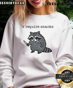 Funny 'I Require Snacks' raccoon with knife sweatshirt design, perfect for animal lovers and humor enthusiasts.