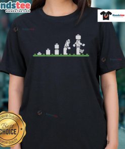 Funny Lego human evolution graphic on a ladies tee, showcasing playful designs with Lego characters and humor.