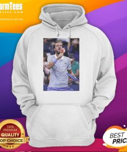 Funny Medvedev licking ice cream on the field at US Open, wearing a hoodie during a lighthearted moment.