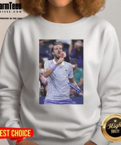 Funny Medvedev licking ice cream on the field at the US Open, wearing a stylish sweatshirt, showcasing a lighthearted moment.