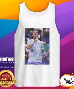 Funny Medvedev licking ice cream on the field in a tank top at the US Open, showcasing a lighthearted moment.