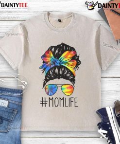 Mom with a funny messy hair bun wearing a tie-dye t-shirt, celebrating Mother's Day in a relaxed, playful style.