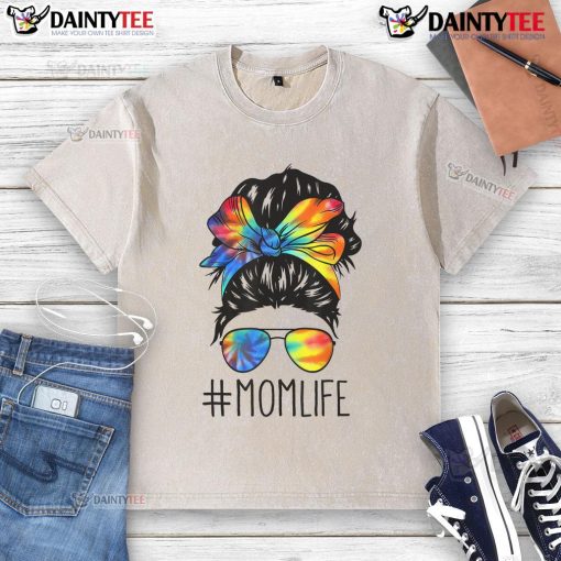 Mom with a funny messy hair bun wearing a tie-dye t-shirt, celebrating Mother's Day in a relaxed, playful style.