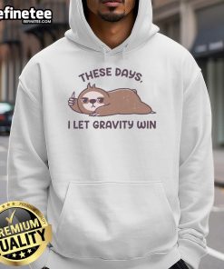 Funny sloth graphic on hoodie with text 'These Days I Let Gravity Win' - perfect for casual wear and animal lovers.