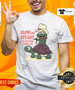 Alt Text: Funny Slow And Steady Cowboy Turtle Frog graphic on a T-shirt, showcasing a humorous take on persistence and patience.