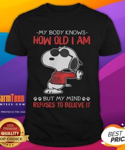 Alt Text: Funny Snoopy t-shirt featuring the phrase My Body Knows How Old I Am But My Mind Refuses To Believe It.