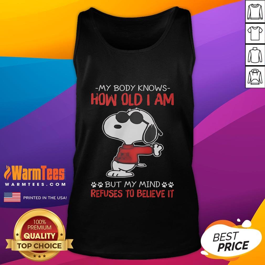 Funny Snoopy My Body Knows How Old I Am But My Mind Refuses To Believe It Tank Top Funny Snoopy tank top with the quote about age, showcasing a playful design that highlights the mind-body age conflict.