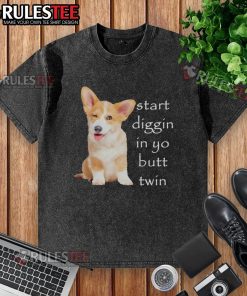 Funny twin corgis digging in the grass with a washed t-shirt, capturing a hilarious moment of playful mischief.