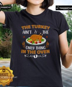 Funny Ladies Tee featuring 'The Turkey Ain't The Only Thing In The Oven' design, perfect for Thanksgiving celebrations.