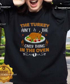 Alt Text: Funny sweatshirt featuring 'The Turkey Ain't The Only Thing In The Oven' design, perfect for Thanksgiving celebrations.